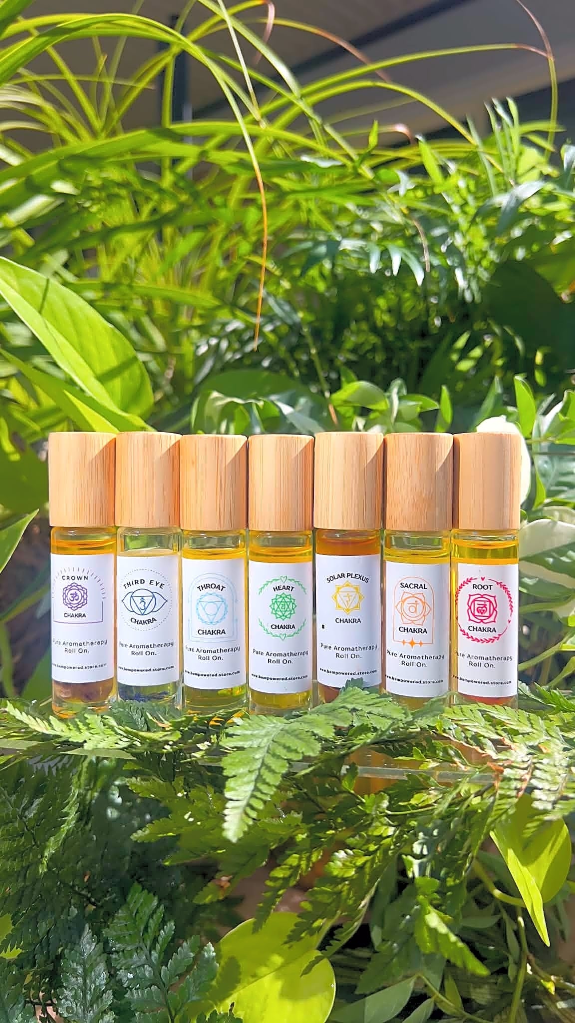 The seven chakra roll-on blends in sunlit greenery